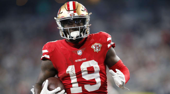 Deebo Samuel carries the football.